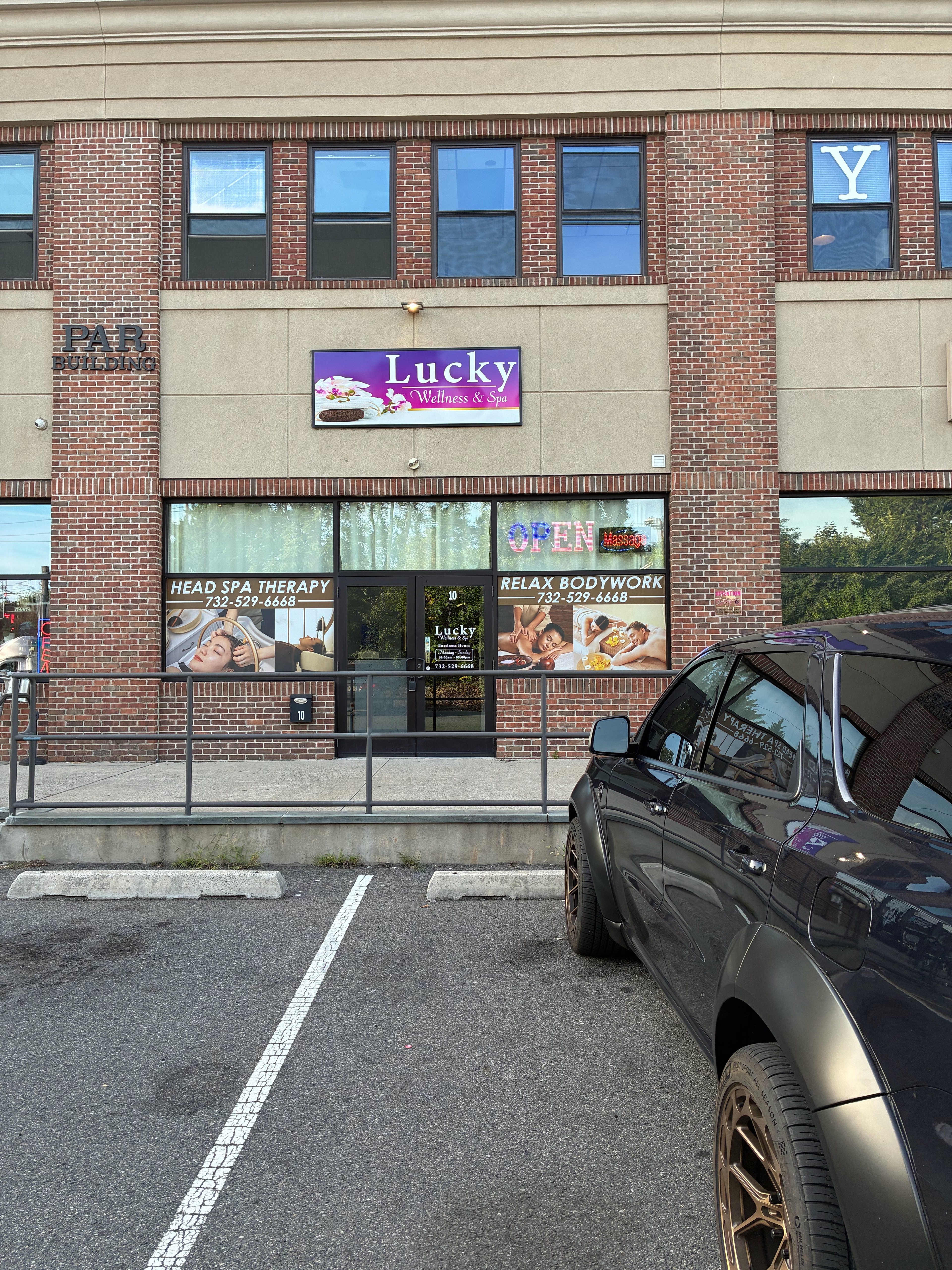Lucky Wellness & Spa storefront signage showing head spa therapy and relax bodywork