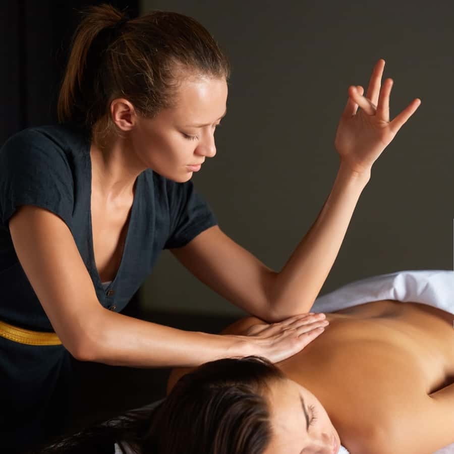 A therapist performing a relaxing back massage at Massage Pure Healing