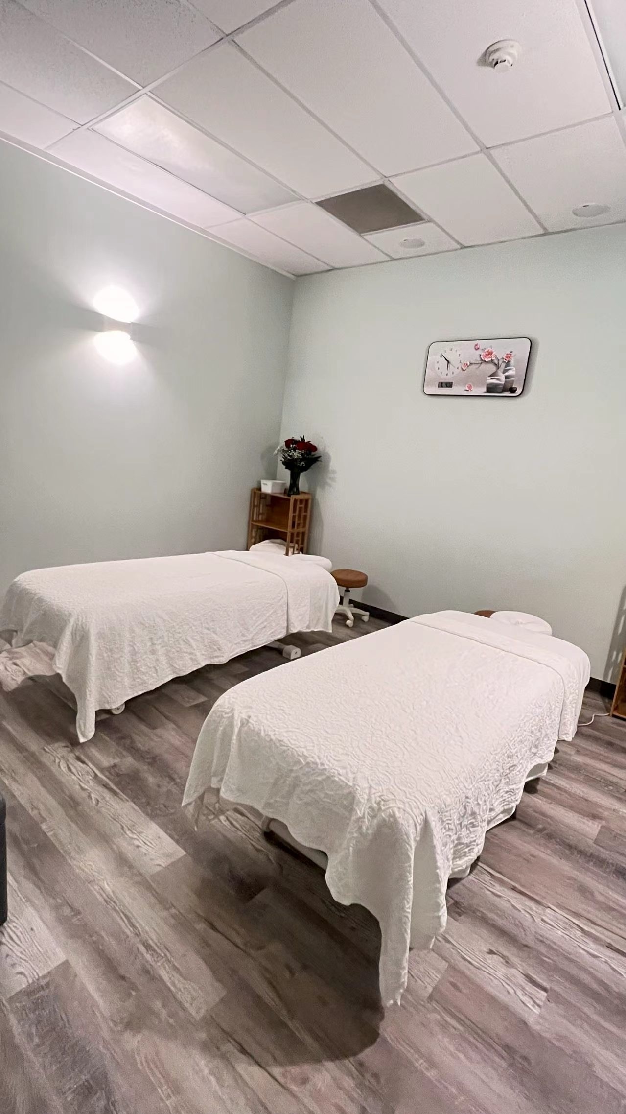 Couples massage room with two side-by-side massage tables
